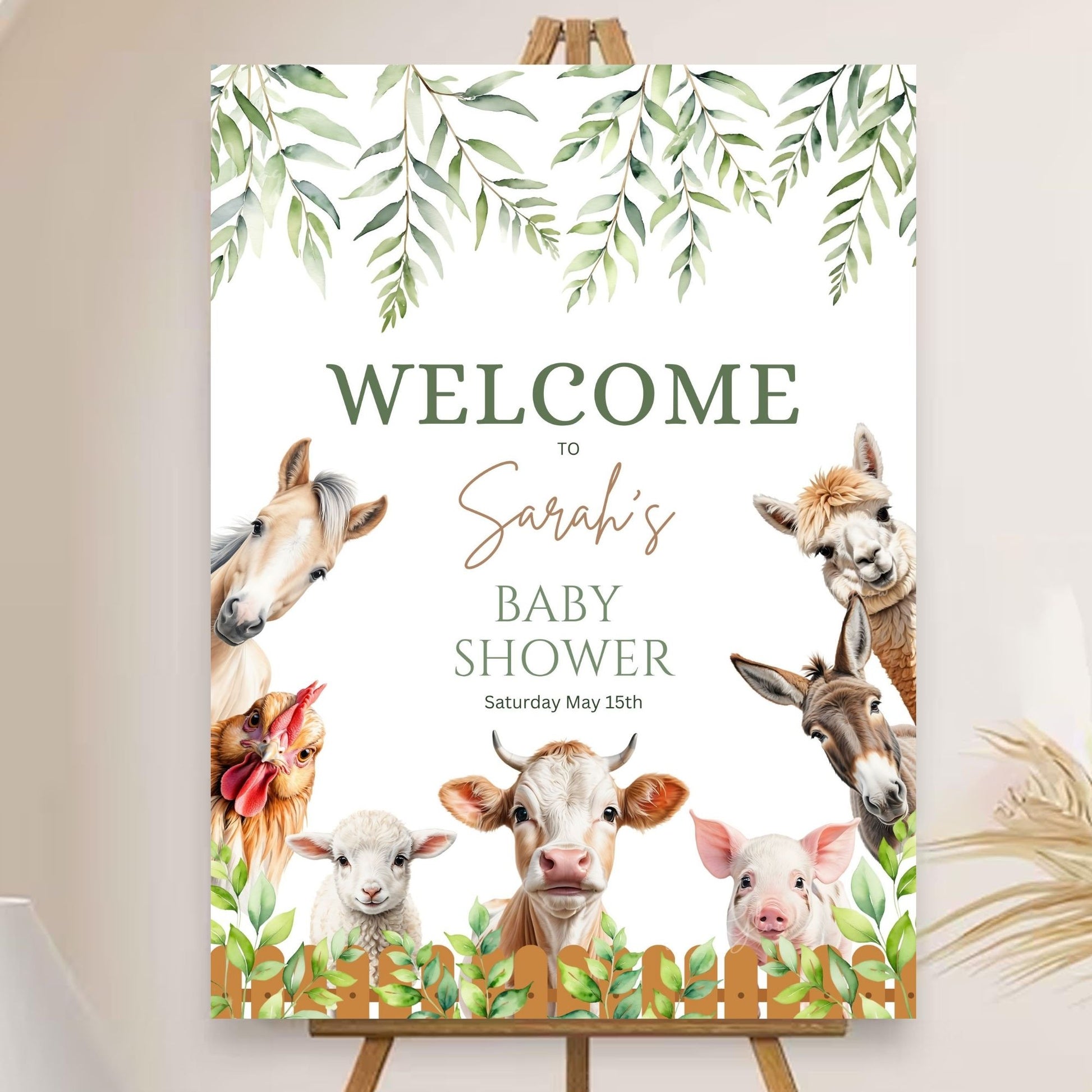 Personalized farm-themed party sign with greenery accents.