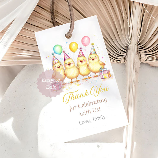 Gift tag with cartoon chicks and balloons on a textured surface