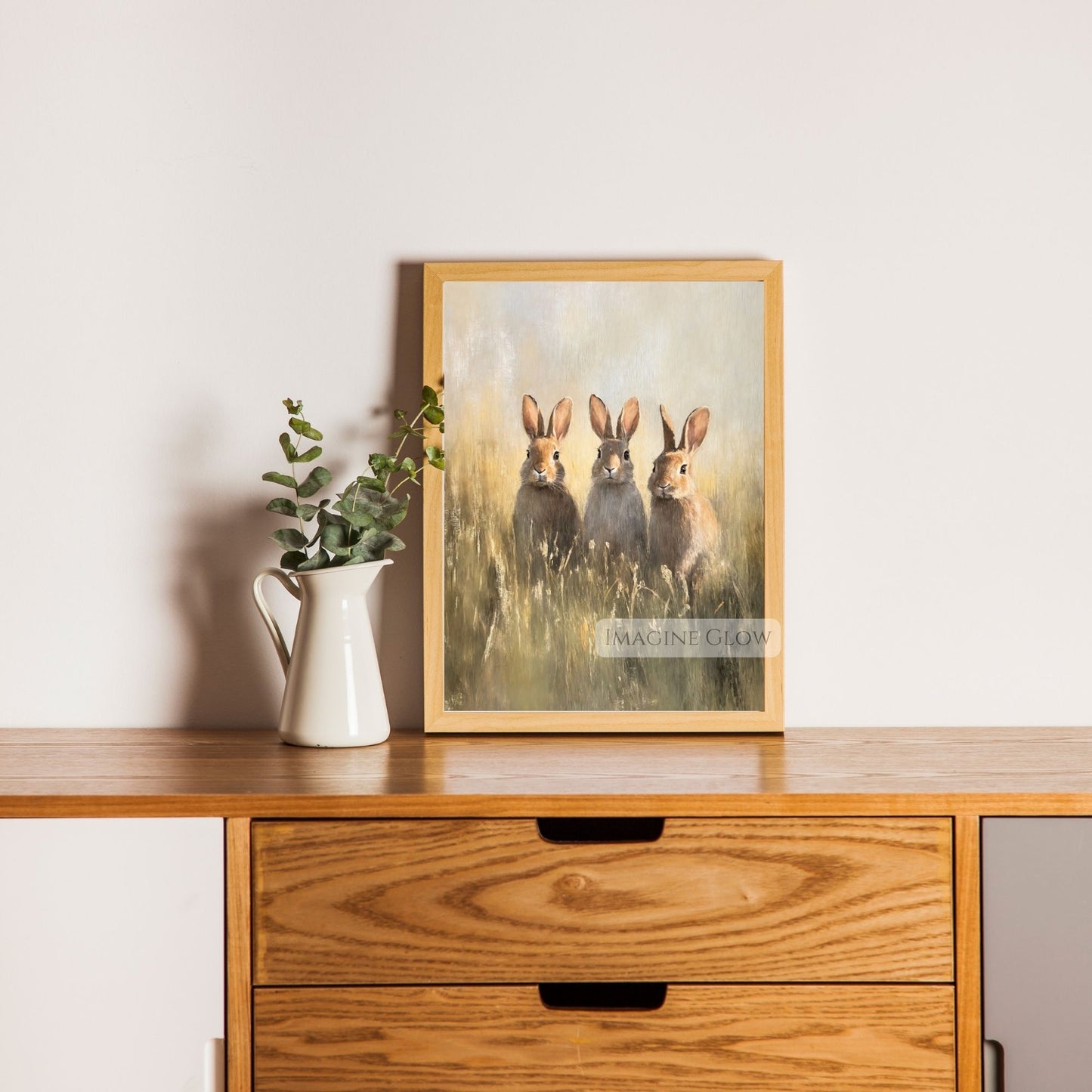 Antique-style print of three bunnies in a meadow