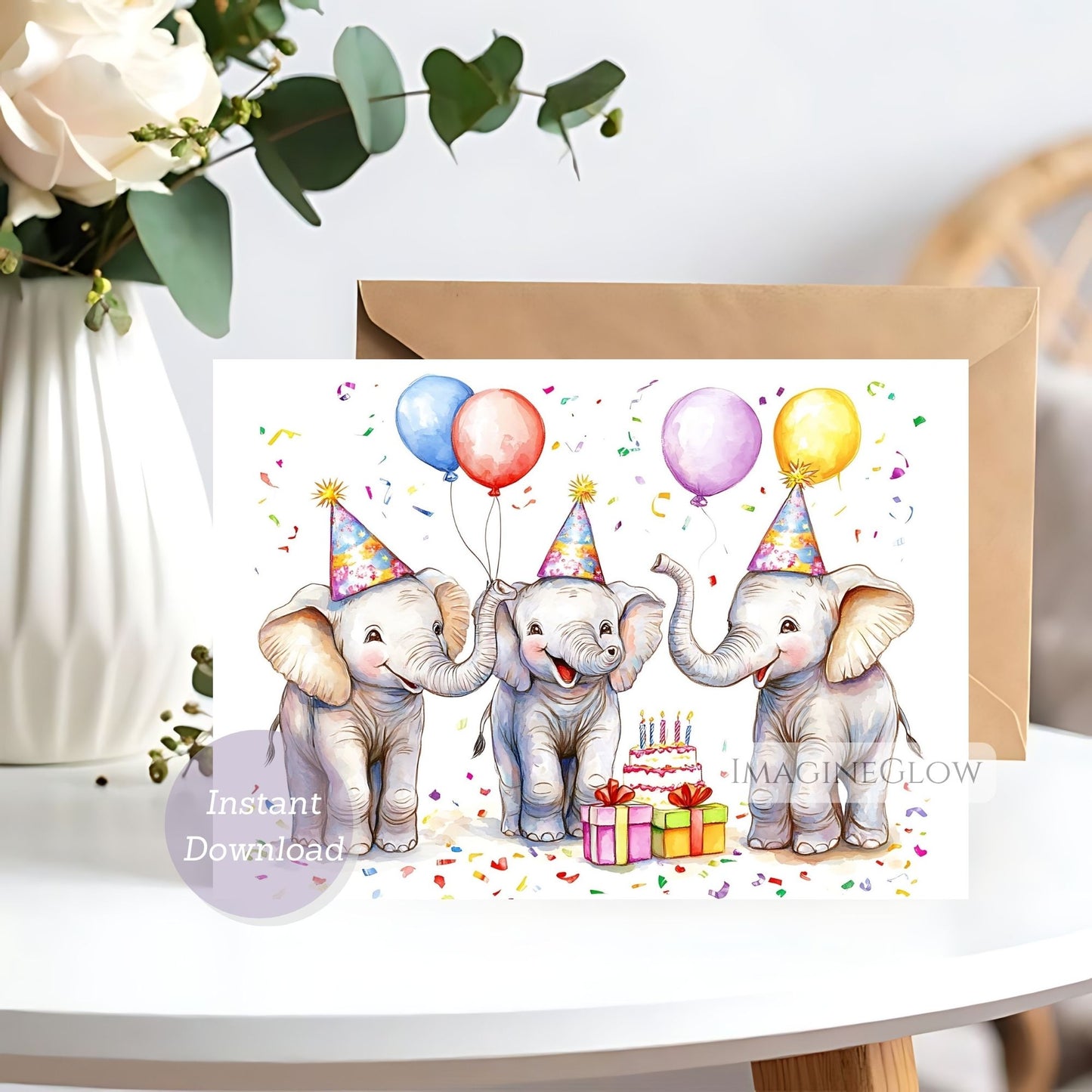 Greeting card with three elephants celebrating a birthday, surrounded by balloons and a cake, on a white surface.