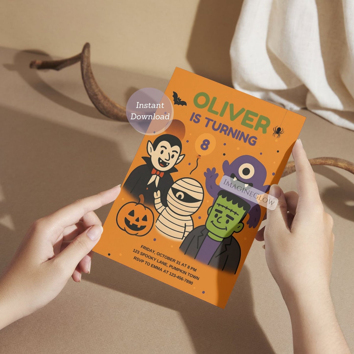 Halloween-themed birthday invitation card held by hands on a neutral background