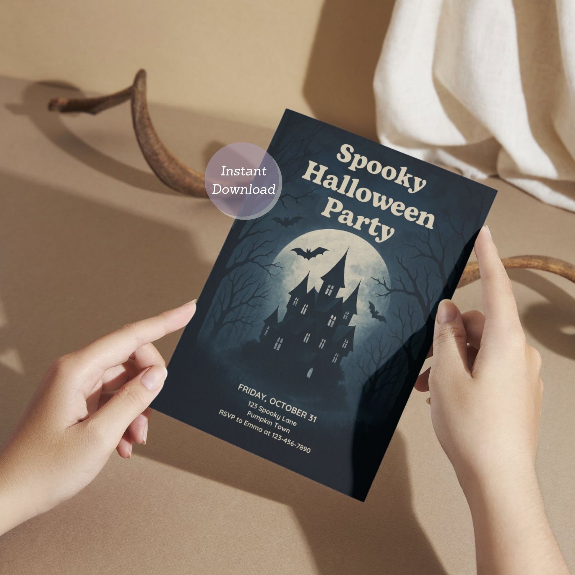 Halloween party invitation with a castle design held by hands on a black background