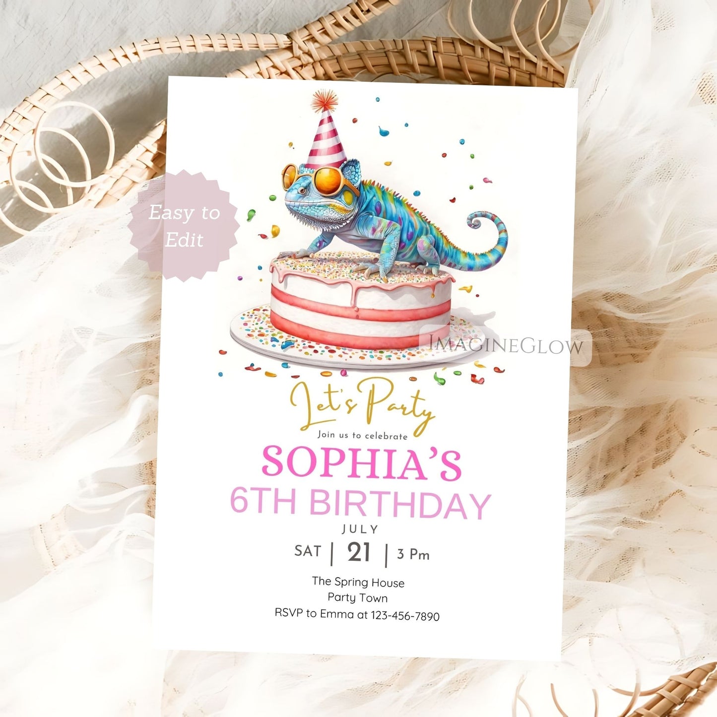 Birthday invitation card with a colorful lizard on a cake, placed on a textured surface.