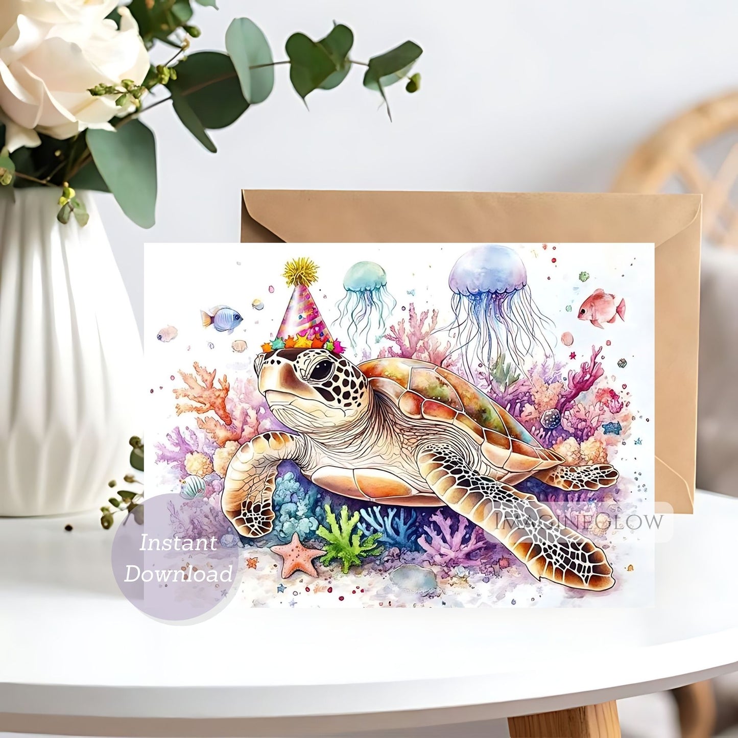 Greeting card with a turtle wearing a party hat surrounded by colorful jellyfish and coral on a white surface.