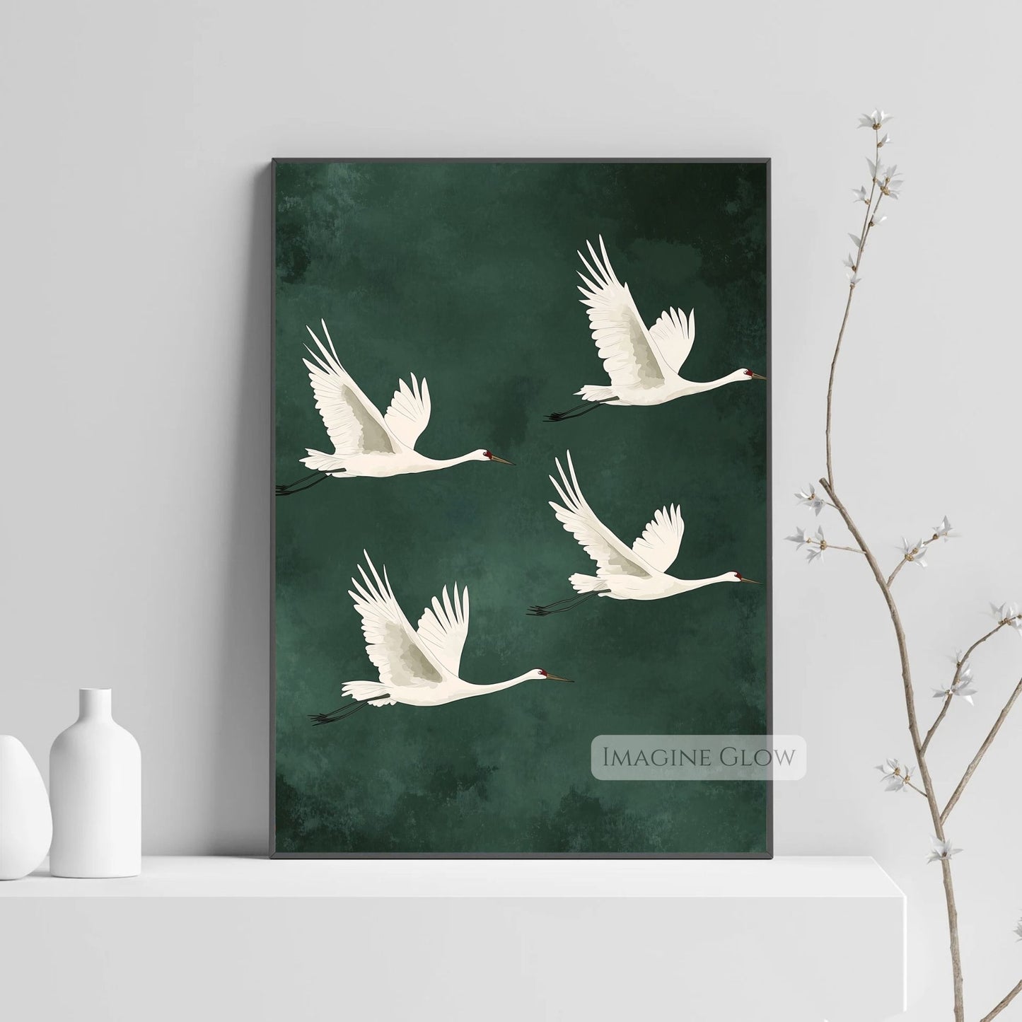 Green wall art featuring Japanese cranes in motion.