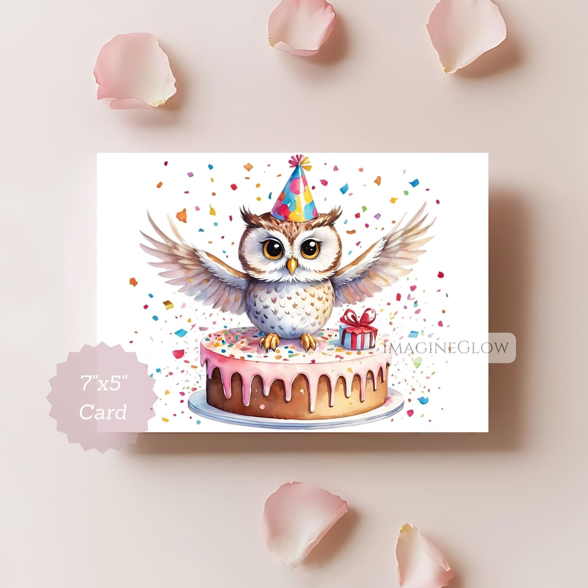 Card with a cartoon owl on a cake, wearing a party hat, surrounded by confetti and rose petals.