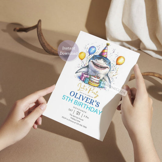 Birthday invitation card with a shark design held by hands on a neutral background