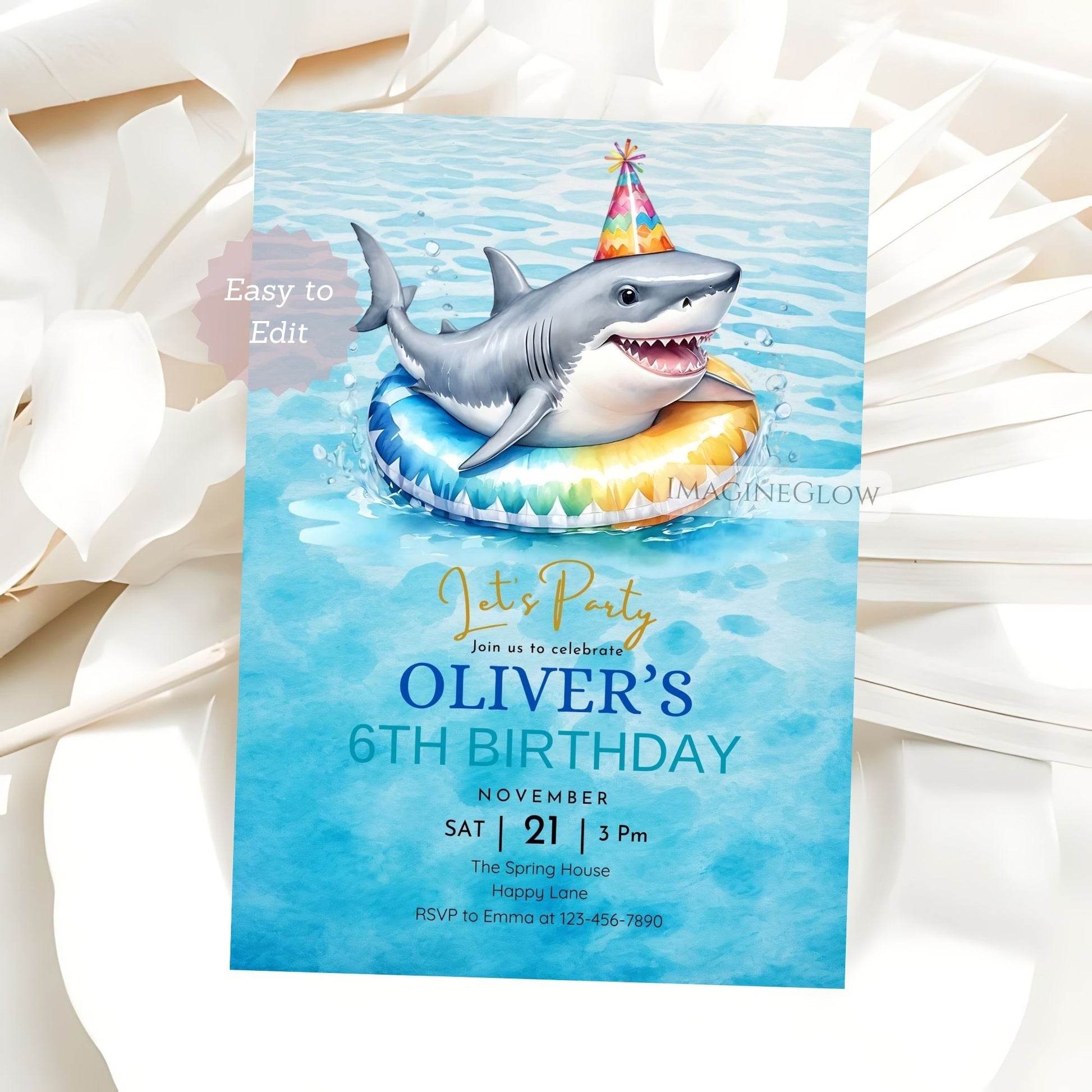 Birthday party invitation with a shark on an inner tube against a blue watercolor background.