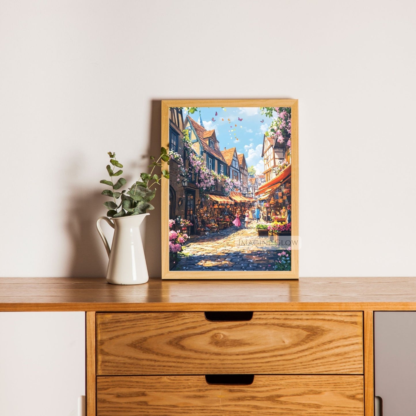 Peaceful summer townscape with cobblestones, pastel buildings, and flowers.