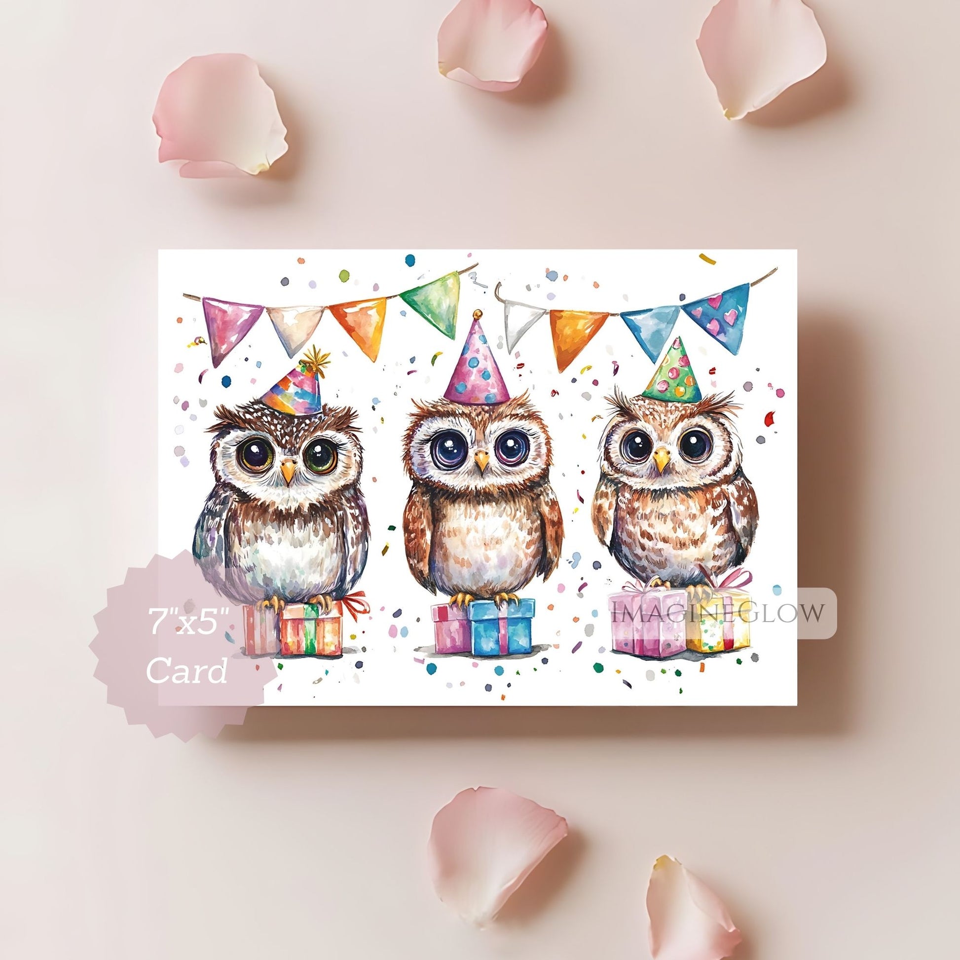 Card with three owls wearing party hats and surrounded by colorful flags and presents on a light pink background.
