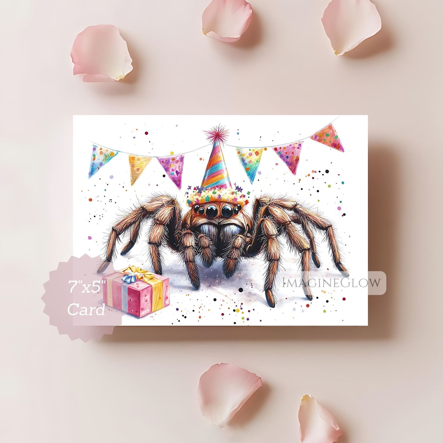 Card with a spider wearing a party hat and surrounded by colorful flags and a gift, on a light pink background with rose petals.