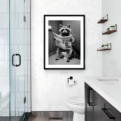 Humorous wall art featuring a raccoon enjoying a newspaper in a toilet