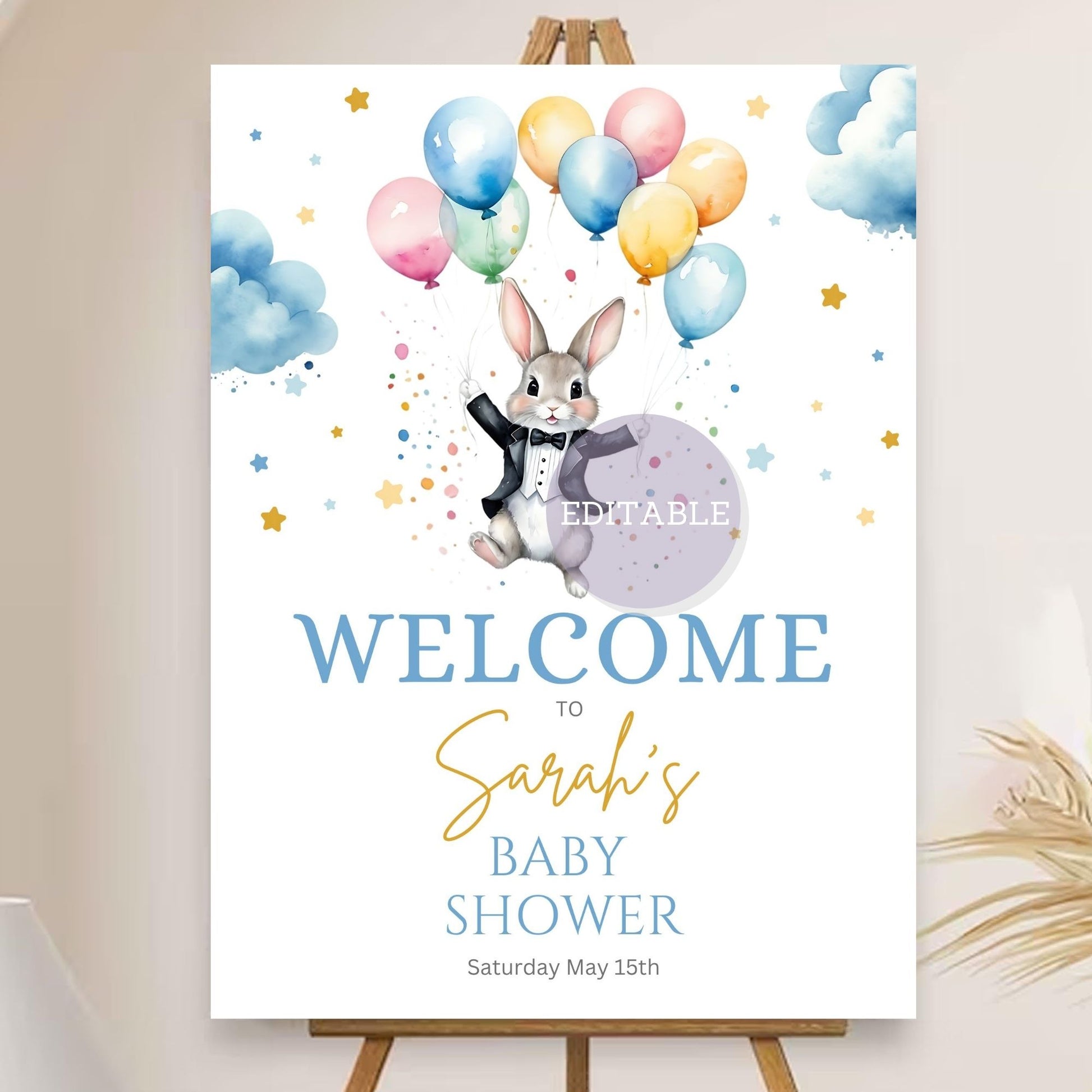 Baby shower welcome sign with balloon and bunny theme for party decor.