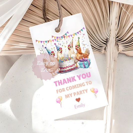 Party favor tag with cartoon chickens around a cake and gift, on a textured surface.