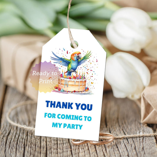 A white party thank-you tag with a colorful parrot and birthday cake illustration, printed with the text 'THANK YOU FOR COMING TO MY PARTY' in blue and light blue.