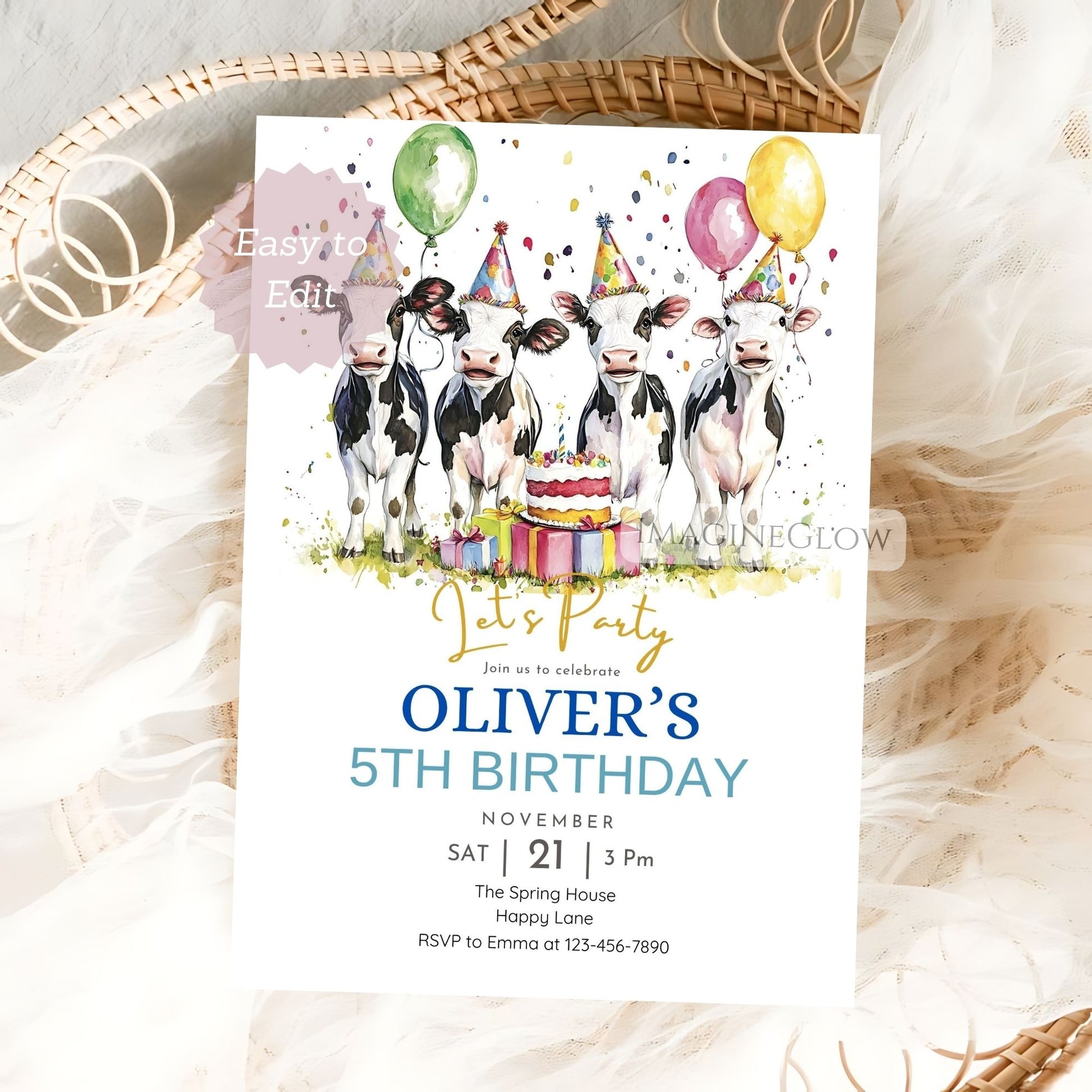 Birthday invitation card with cows, balloons, and a cake on a textured surface.