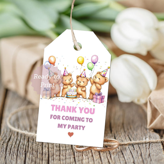 Party favor tag with teddy bears and balloons on a wooden surface