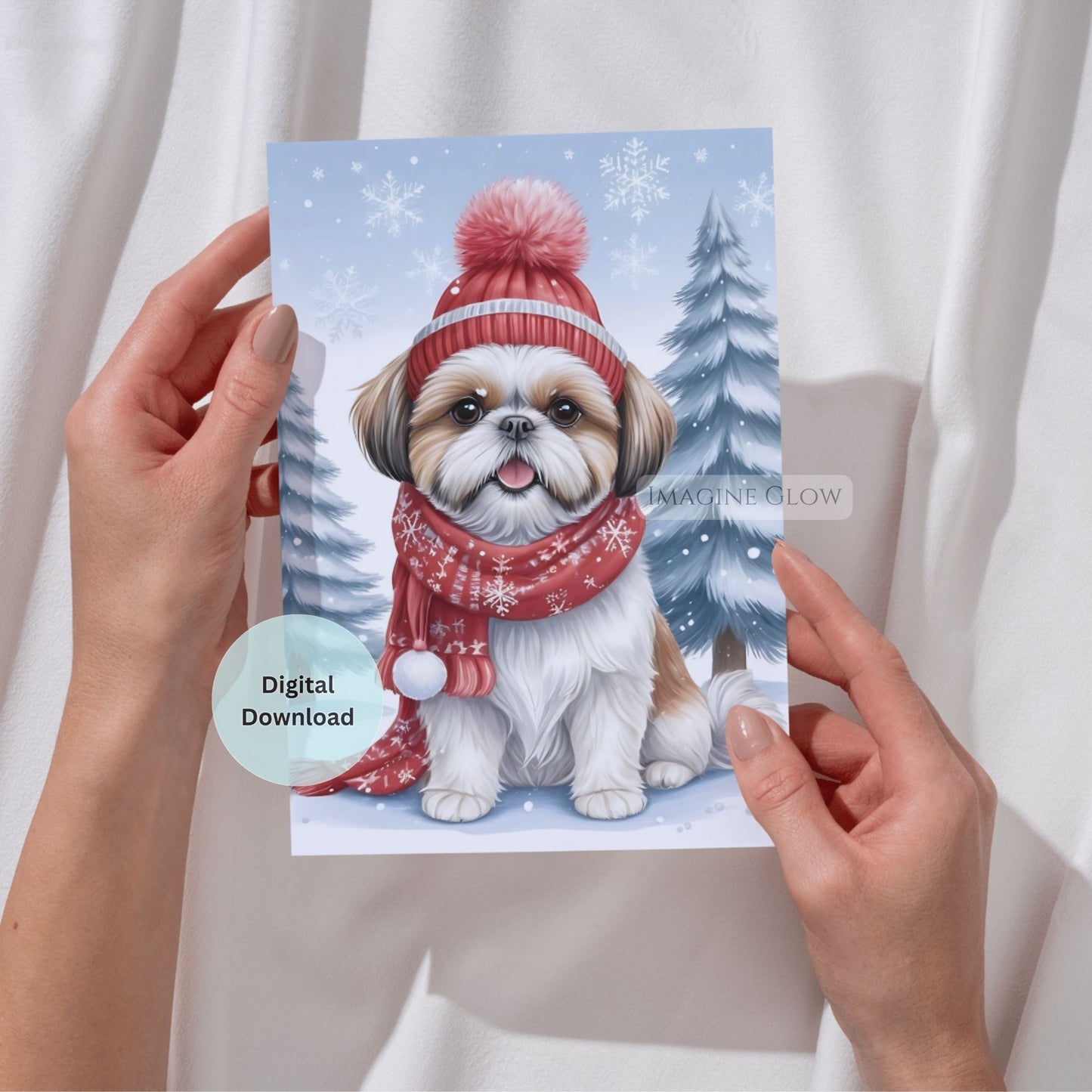 Card with a dog wearing a winter hat and scarf held by hands against a white background
