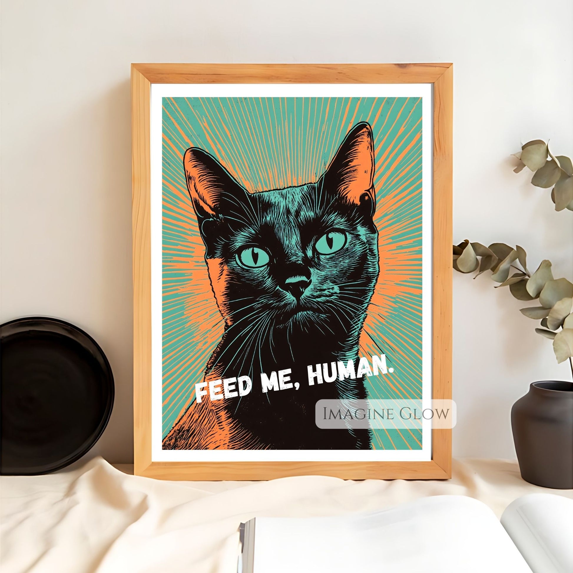 Pop art black cat wall art with "Feed Me, Human" text.
