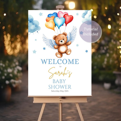 Baby shower welcome sign featuring teddy bear and angel balloons.
