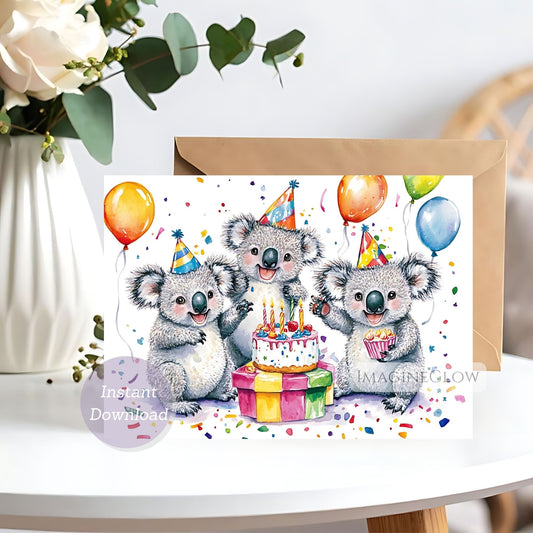 Birthday card with koalas and balloons on a white surface