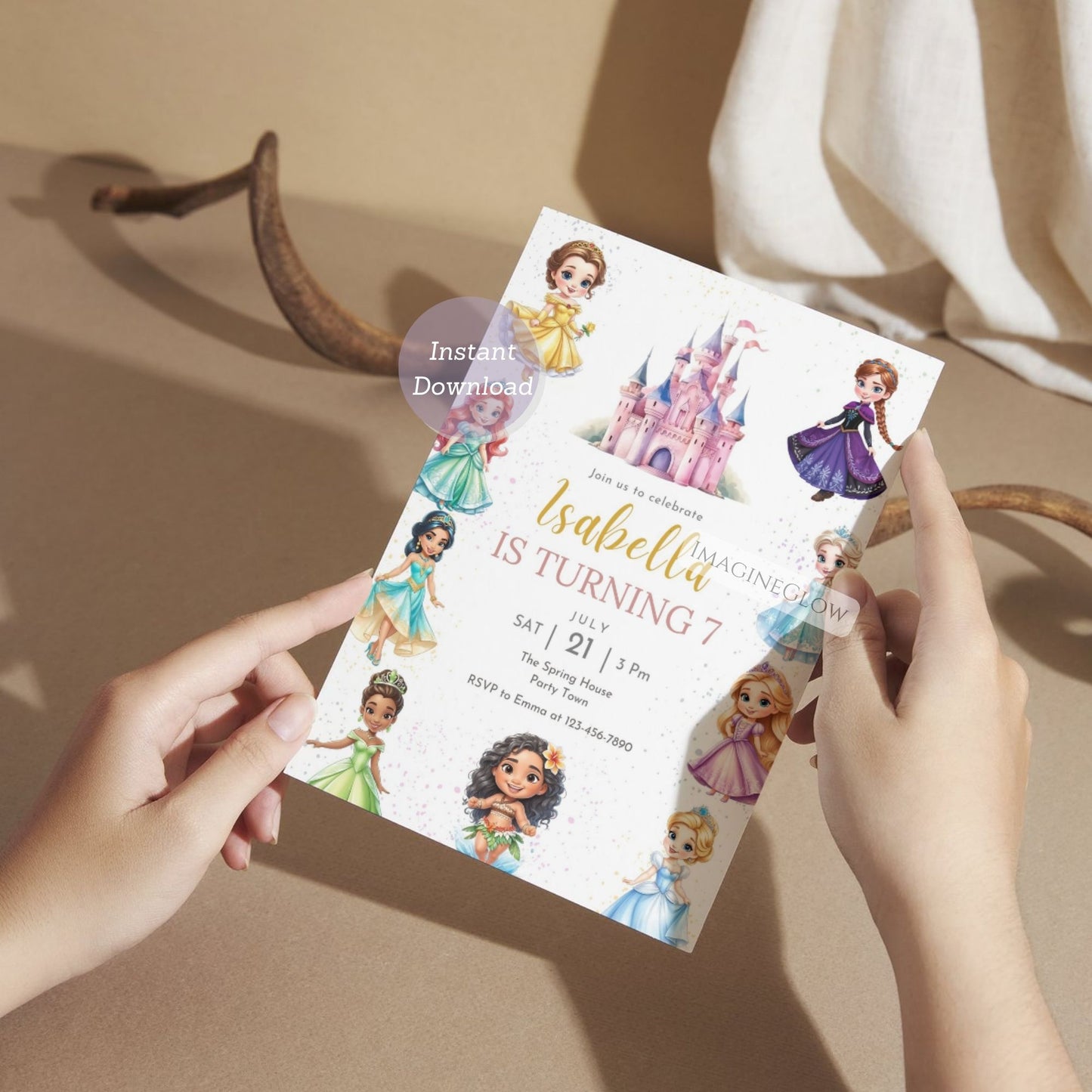 Person holding a birthday invitation card with princess designs on a neutral background