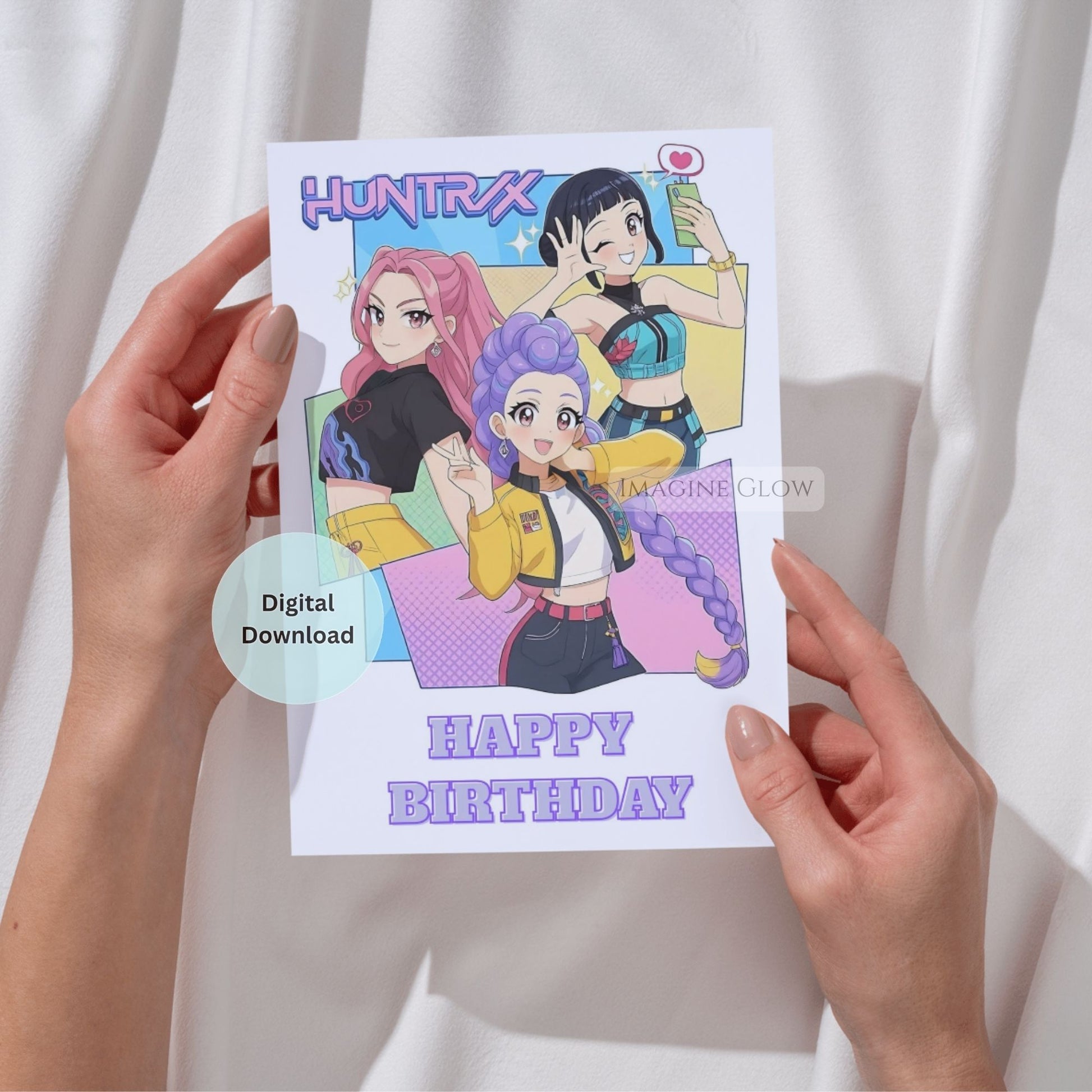 Huntrix digital birthday card held by hands against a white background
