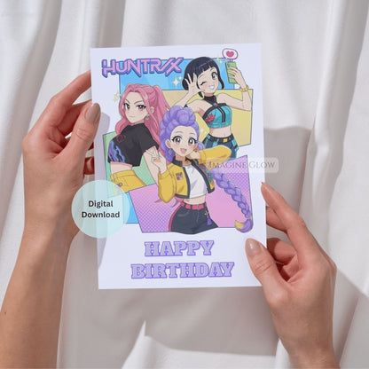 Huntrix digital birthday card held by hands against a white background