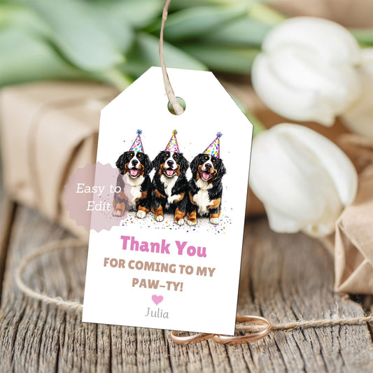 Gift tag with three Bernese Mountain dogs wearing party hats on a white background.