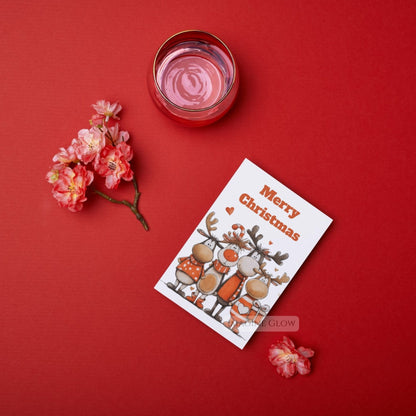 Merry Christmas card with a candle and flowers on a red background