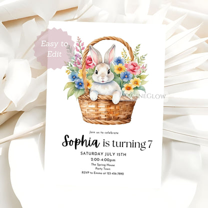 Invitation card with a rabbit and flowers in a basket on a white background
