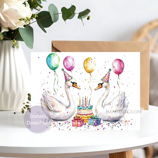 Birthday card with swans, balloons, and a cake on a white surface with flowers in the background.