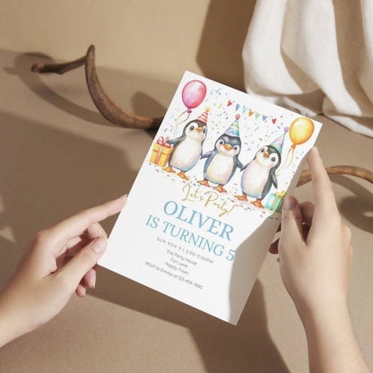 Cute penguin birthday invite for winter celebration.